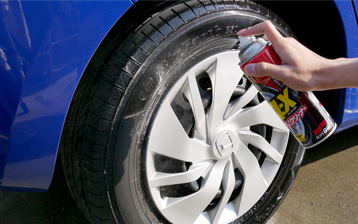 スプレーをタイヤに吹き付ける