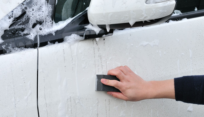 Use the black sponge to remove stubborn water streaks.