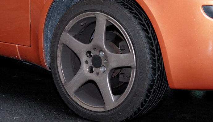 A stylish car rests on stylish tires.